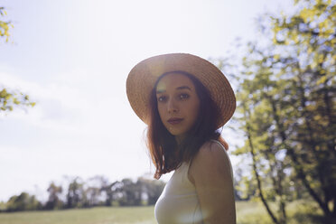 Portrait of young woman wearing straw hat in nature - GIOF000910