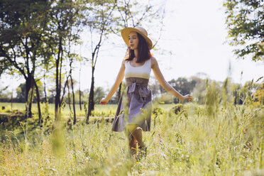 Young woman dancing on a meadow in spring - GIOF000922