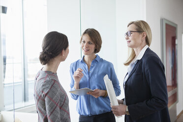 Three businesswomen discussing in office - RBF004497