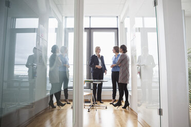 Three businesswomen talking at the window - RBF004513