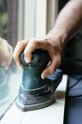 Man sanding a windowsill - HAWF000888