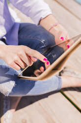 Young woman using digital tablet, close-up - BOYF000299