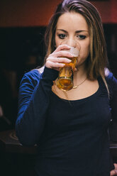 Woman drinking a glass of beer - ABZF000385