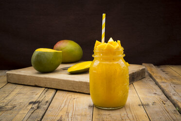 Glass of mango smoothie garnished with diced mango - LVF004837