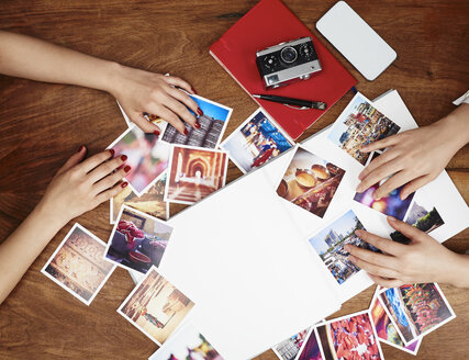 Hands sorting photo prints - DISF002483