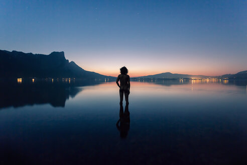 Austria, Lake Mondsee, Rear view of nude man standing in water - WV000753