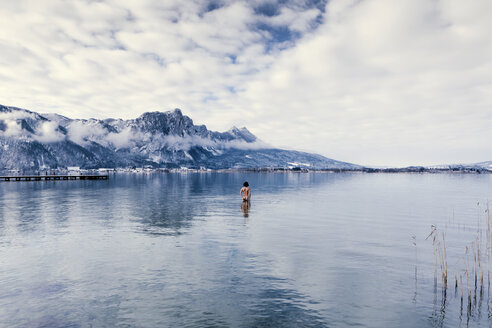 Austria, Lake Mondsee, Rear view of nude man standing in water - WV000759