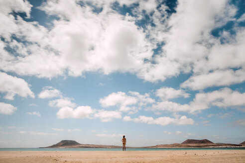 Lanzarote, Rear view of nude man standing on Playa del risco - WV000772