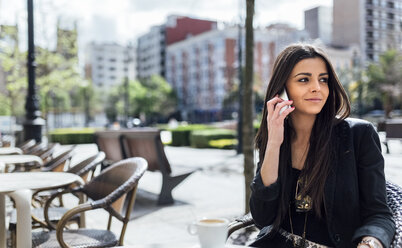 Junge Frau mit Smartphone beim Kaffee trinken - MGOF001793