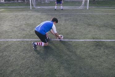 Football player placing the ball on the line in front of the goal - ABZF000452