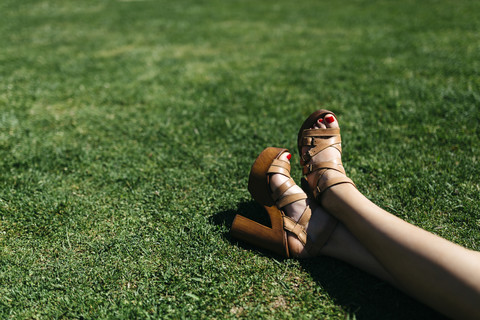 Feet of woman relaxing on lawn stock photo