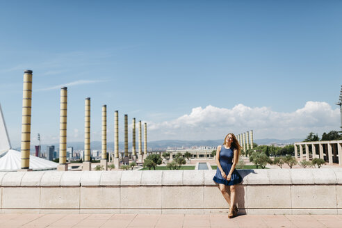 Spain, Barcelona, smiling woman relaxing at sunlight - JRFF000604