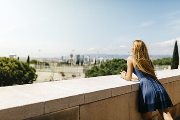 Spain, Barcelona, back view of woman leaning on balustrade while looking at view - JRFF000611