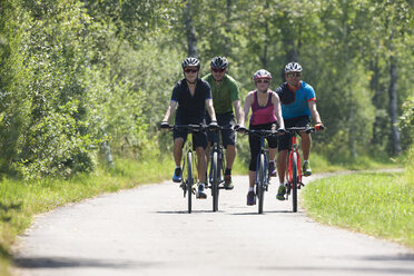 Four people on a bicycle tour with trekking bikes - DSF000650