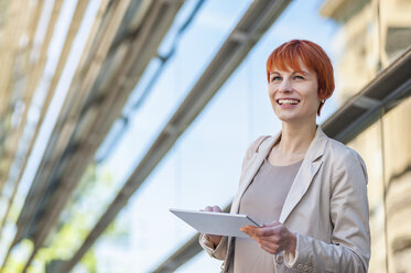 Smiling young woman outdoors with digital tablet - DIGF000456