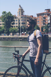 Spain, Bilbao, man with racing cycle on the river - RTBF000191