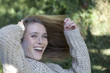 Portrait of young woman, hand in hair - MAEF011559