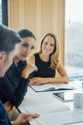 Smiling businesswoman in a meeting - CHAF001705