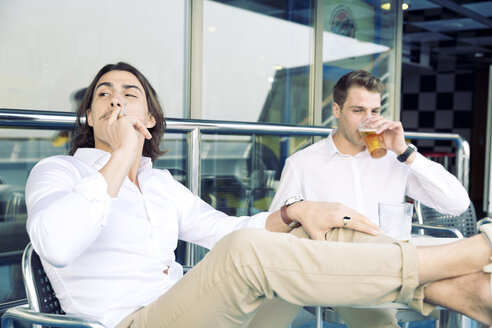 Two young men smoking and drinking beer on cruise ship - SEF000903