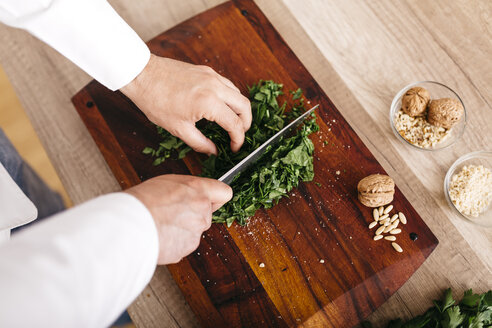 Chef preparing stuffing for ravioli, chopping spinach - JRFF000640