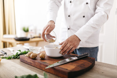 Chef preparing stuffing for ravioli, mixing ingredients - JRFF000642