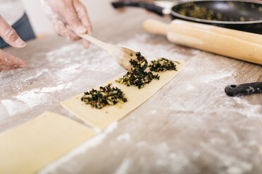 Chef putting ravioli stuffing on dough - JRFF000656