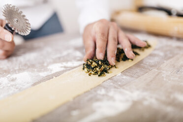 Chef putting ravioli stuffing on dough - JRFF000661
