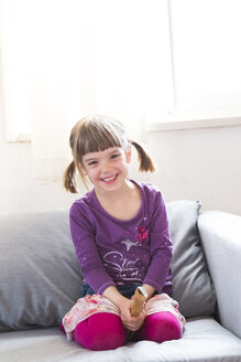 Happy little girl with recorder at home - LVF004869