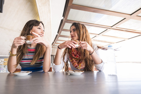 Two friends drinking coffee stock photo