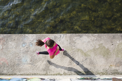 Young woman running at lakeshore - MRAF000022