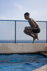 Low section of girl wearing striped underwear while diving into swimming  pool stock photo