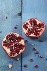 Sliced pomegranate on blue wood - RTBF000195