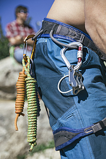 Ropes and carabiners in the harness of climber stock photo