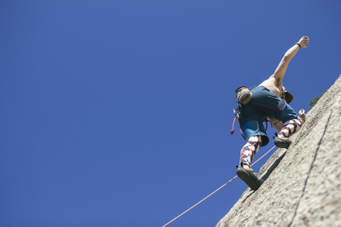 Man climbing without hands stock photo