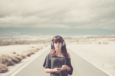 Young woman on the road listening music with headphones - SIPF000472