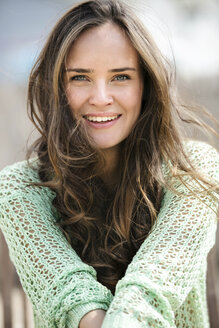 Portrait of smiling young woman with long brown hair - GDF000988