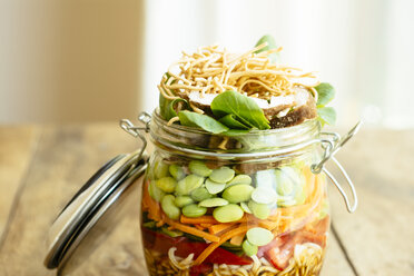 Asian salad in a jar with ramen noodles, red pepper, snow pea pods, carrots, edamame, shiitake mushrooms, salad greens, fried chow mien noodles and dressing - HAWF000900