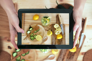 Frau fotografiert Lebensmittel mit digitalem Tablet - RTBF000208