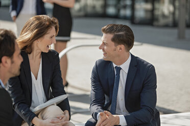 Business colleagues having fun outdoors - CHAF001729