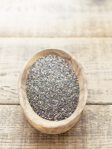 Chia seeds in a wooden bowl stock photo