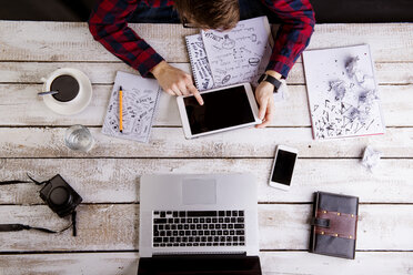 Man working at desk with laptop and digital tablet - HAPF000367