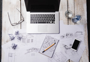 Desk of an architect with laptop and sketches - HAPF000374