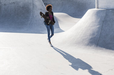 Junge Frau geht im Skatepark - UUF007258