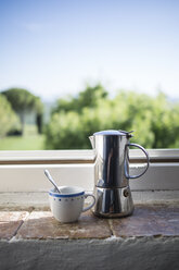 Espresso can and coffee cup by the window - RIBF000411