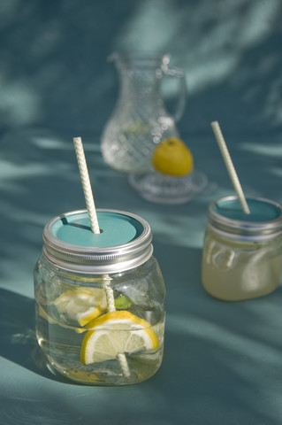 Upcycling of old jam jars, Lemonade and drinking straw stock photo