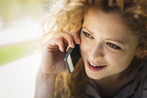 Porträt einer Frau, die mit einem Smartphone telefoniert, lizenzfreies Stockfoto