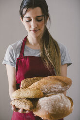 Frau mit verschiedenen hausgemachten Brotsorten - EBSF001396