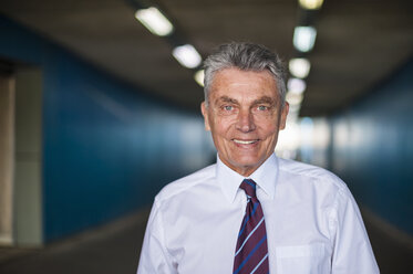 Portrait of confident senior businessman in tunnel - DIGF000554