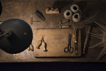 Tools and twine rolls on a wood table in a workshop - ABZF000567