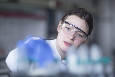 Lab technician examining sample - SGF002055